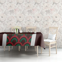 Maroon tablecloth with colorful Mexico emblem and wave pattern on table top