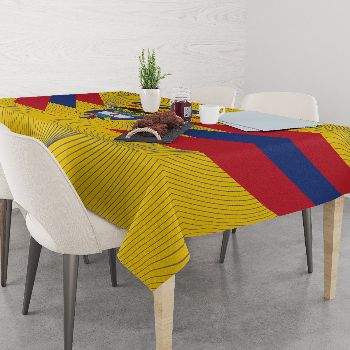 Yellow Colombia football tablecloth with blue and red stripes over table with items