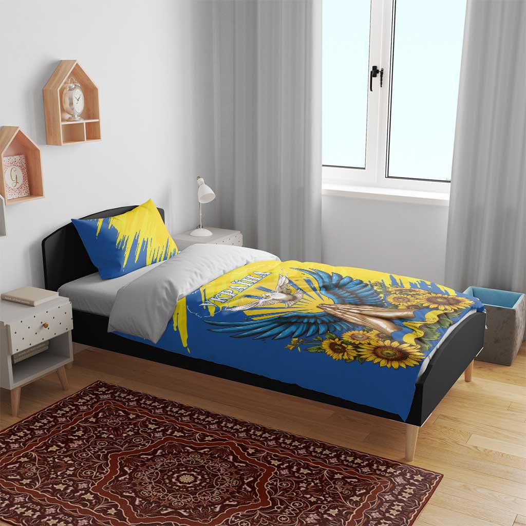 Blue bedding set with sunflower and dove print, shown on a made bed