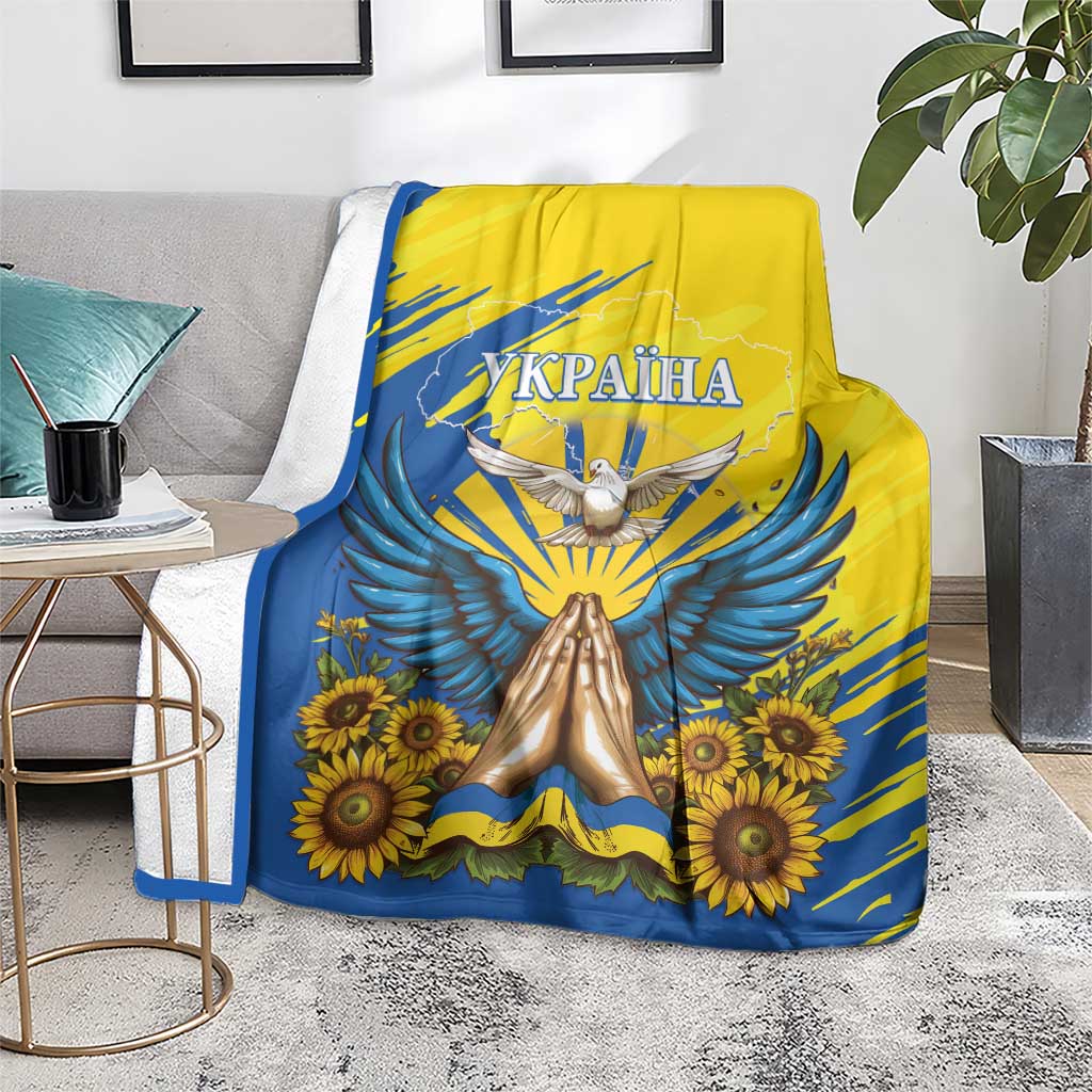 Blue and yellow Ukraine graphic blanket with dove, wings, and sunflower clusters