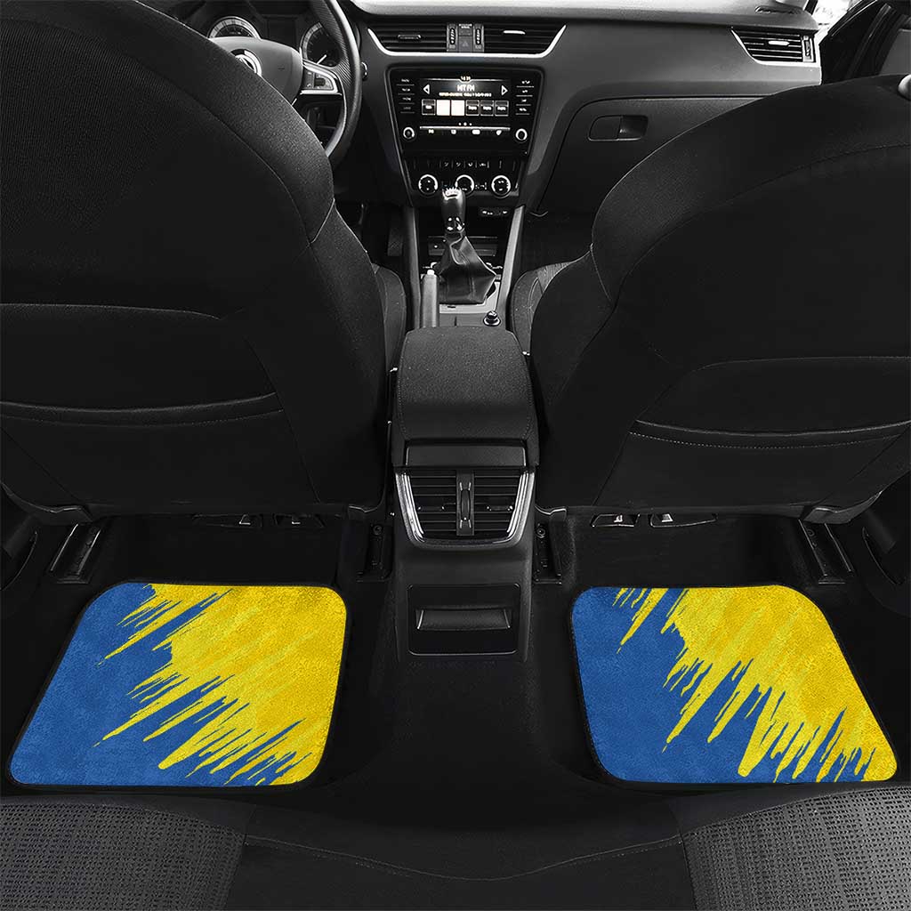 Blue car floor mats on front seats with gold dove and sunflower graphic pattern
