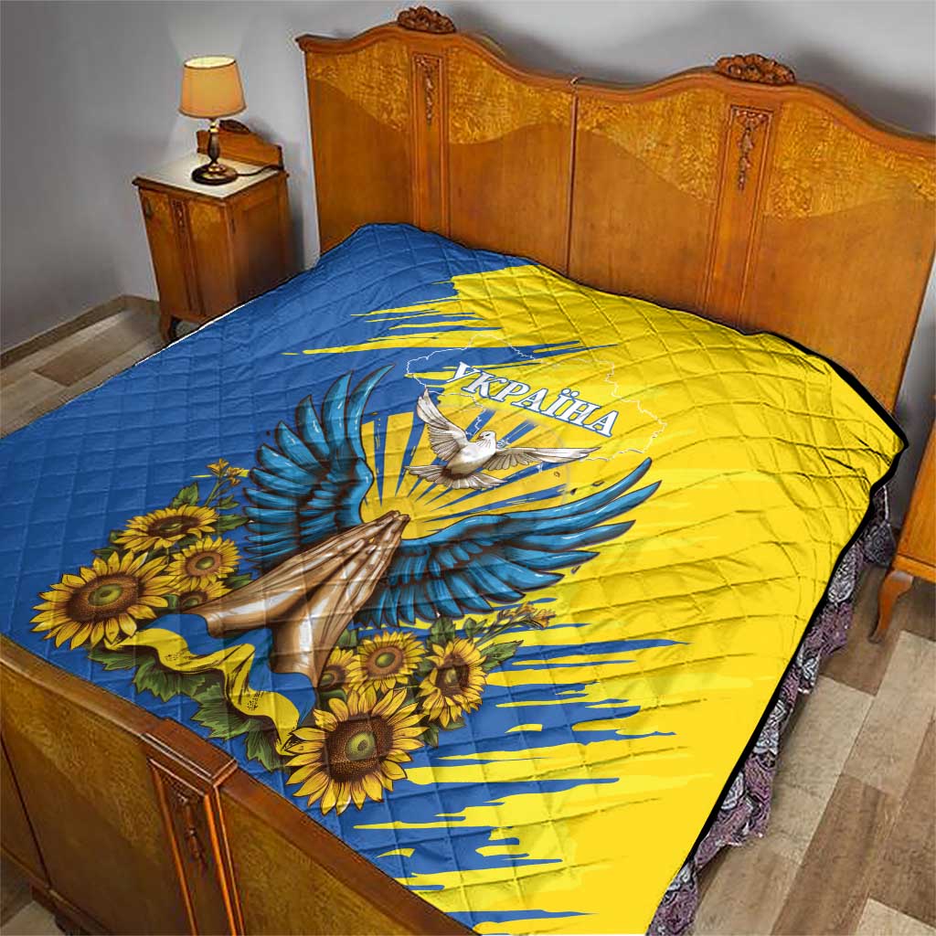 Blue and yellow quilt with dove, sunflowers, and Ukraine text