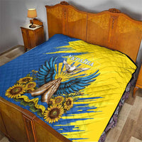 Blue and yellow quilt with dove, sunflowers, and Ukraine text