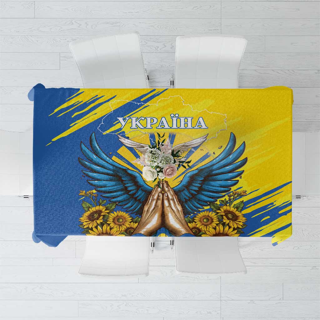 Blue and yellow tablecloth with dove, flowers, and 'UKRAINA' text center