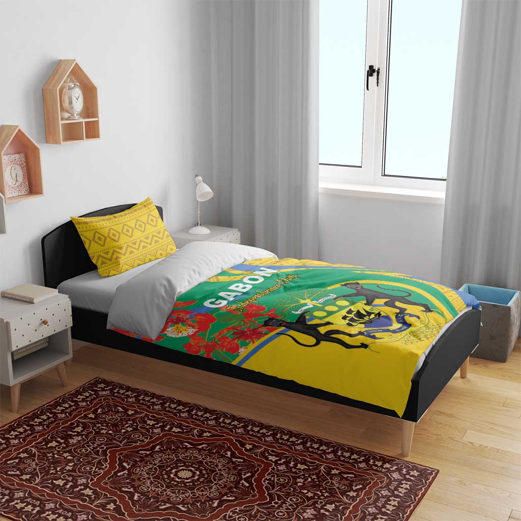 Bedding set on single bed: yellow pillowcases and green duvet with crest and red floral details