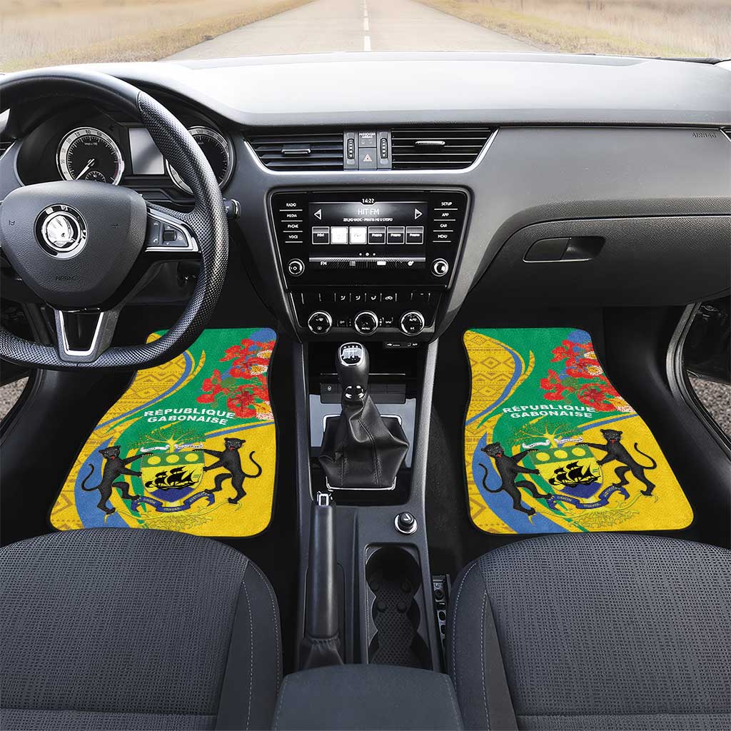 Two green-and-yellow car floor mats with Gabon text and lion crest by gear area