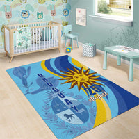 Blue rectangular rug with golden sun emblem, “25 August” text, and yellow crescent waves