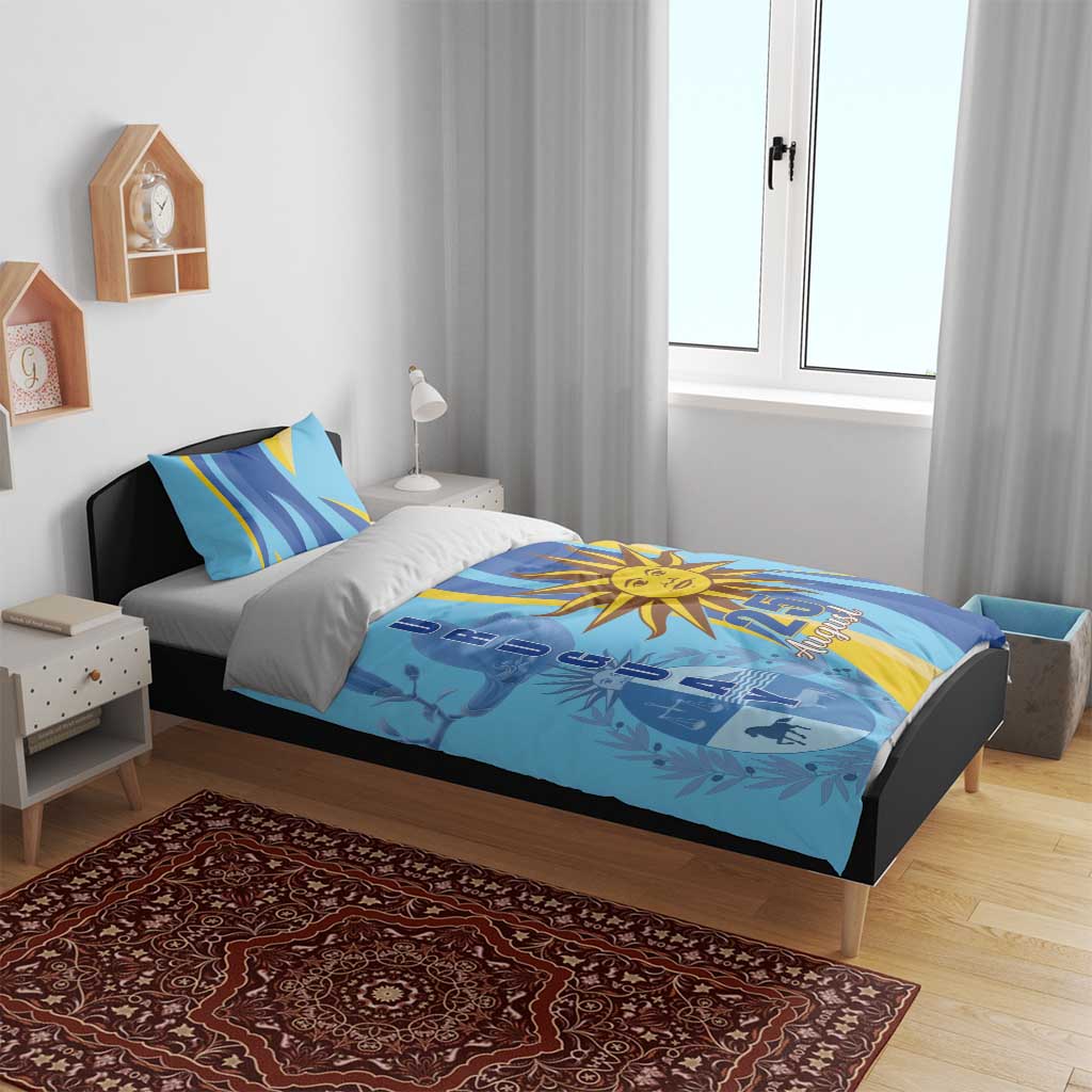 Blue bedding set with sun emblem and 25 August, shown with two matching pillowcases