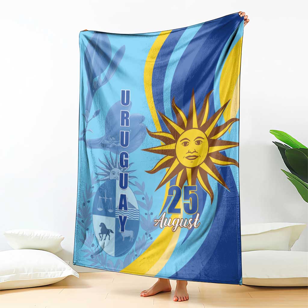 Blue Uruguay Independence Day blanket draped with sun "25 August" graphic and silhouettes