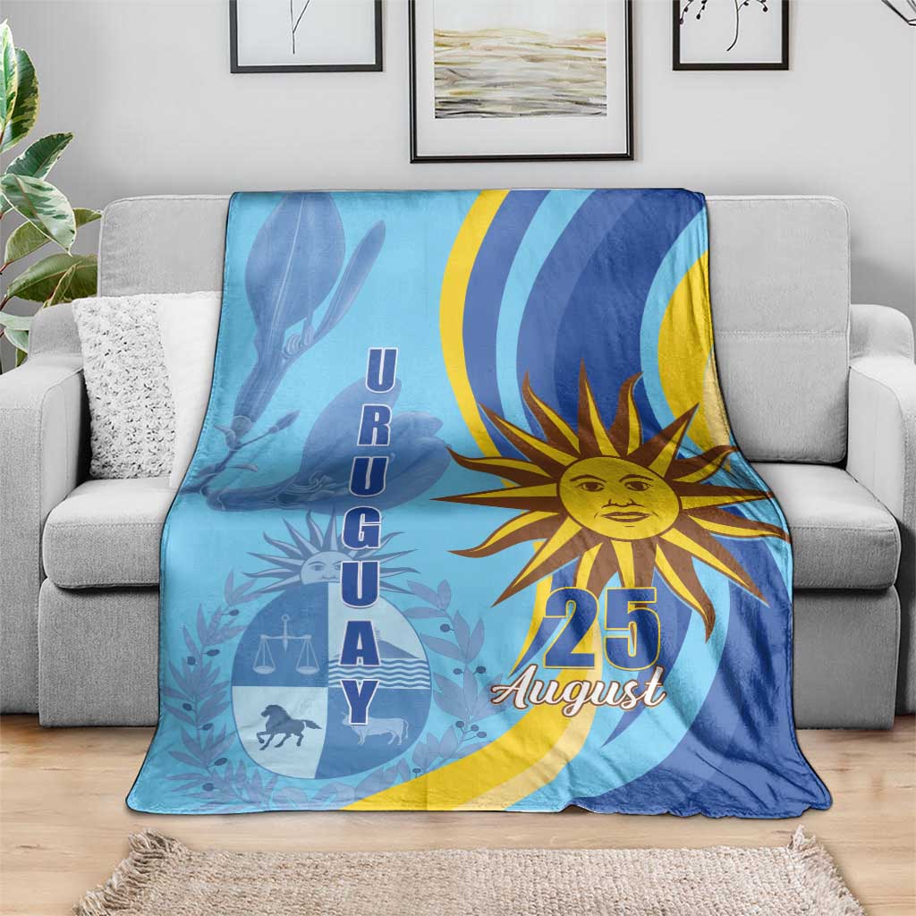 Blue Uruguay Independence Day blanket folded on sofa, sun "25 August" center design