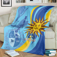Blue Uruguay Independence Day throw blanket with large sun, "25 August" text and graphics