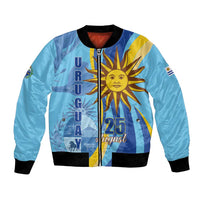 Blue bomber jacket with front zipper, black ribbed cuffs, bold sun-and-flag graphic