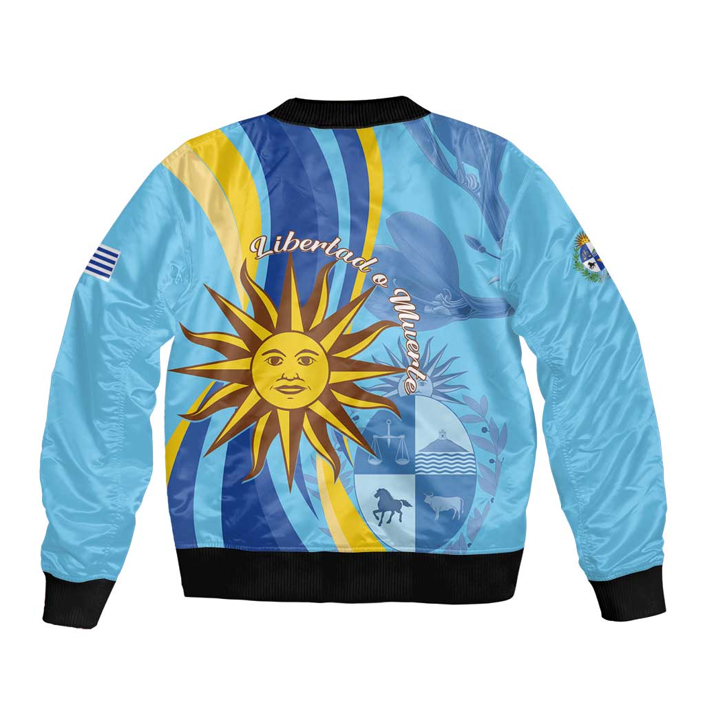 Blue bomber jacket back with sun emblem and striped flag design, black ribbed hem and cuffs