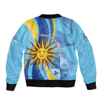 Blue bomber jacket back with sun emblem and striped flag design, black ribbed hem and cuffs