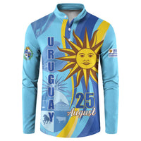 Light blue button sweatshirt with large sun emblem, “URUGUAY” text, and “25 August”