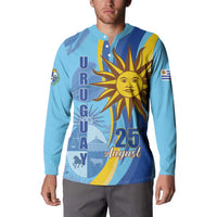 Light blue button sweatshirt with sun graphic and “25 August” lettering on front