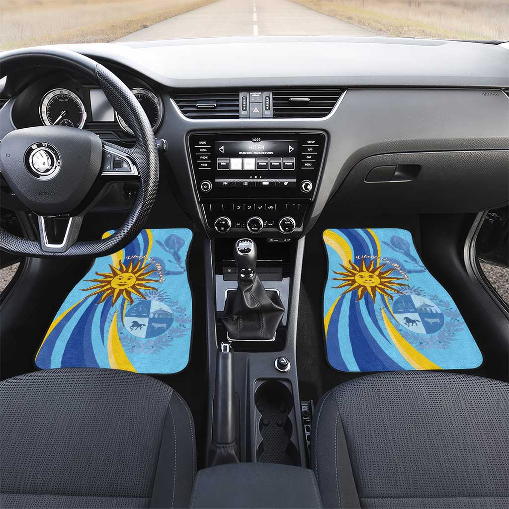 Blue car floor mat set for front seats with sun emblem and wave pattern