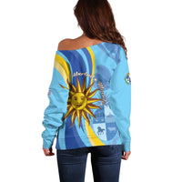 Women’s light blue off-shoulder sweater, back view, sun and “libertad” print