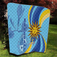 Light blue quilt with quilted texture, yellow sun, and “25 August” centered design