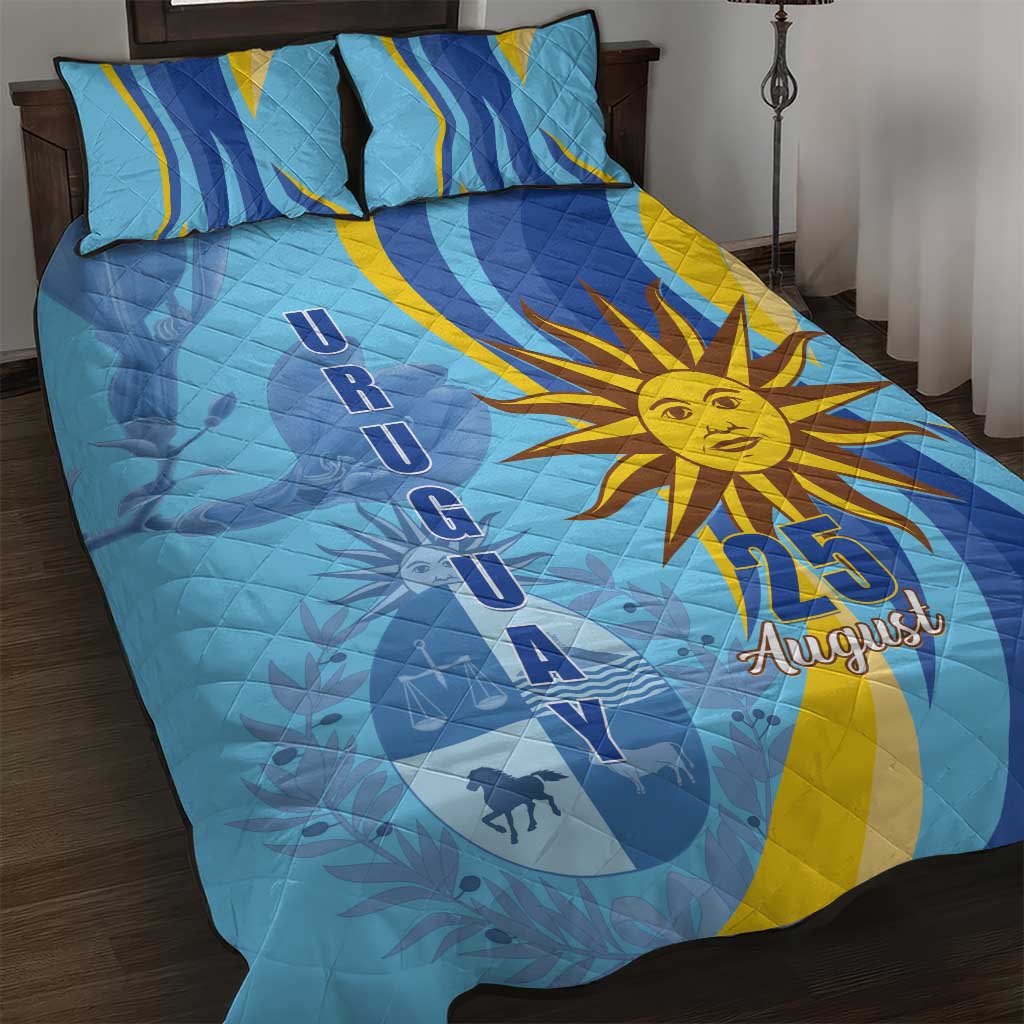 Blue quilt and two pillow shams with sun emblem and 25 August, arched banner motif