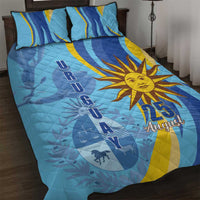 Blue quilt and two pillow shams with sun emblem and 25 August, arched banner motif
