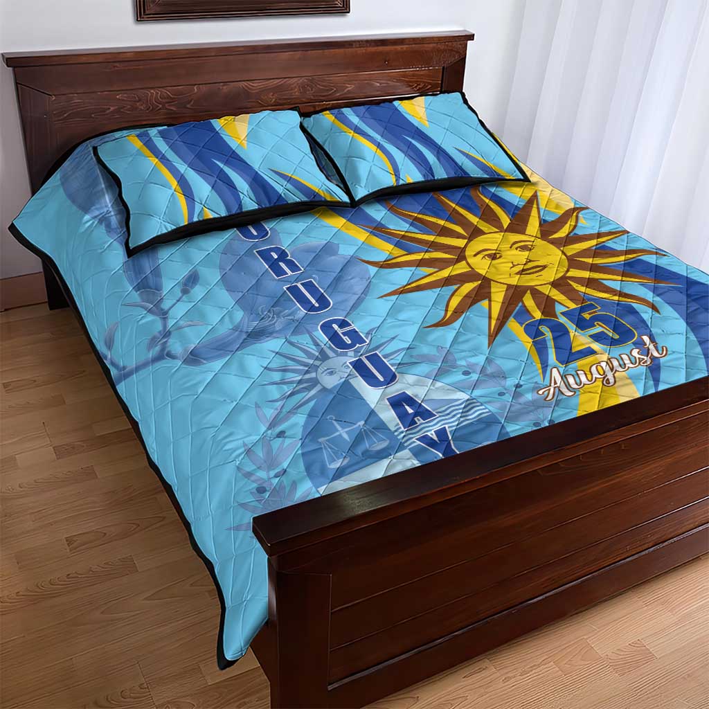 Blue quilt and two pillow shams with sun emblem, 25 August text, diagonal ribbon motif