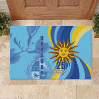 Blue rubber doormat with sun emblem and “25 August” text, Independence Day design