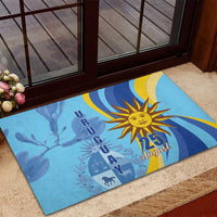 Blue rubber doormat with sun emblem and “25 August” graphic on entry step