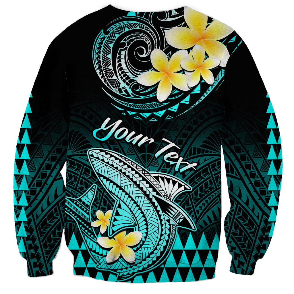 Turquoise and black sweatshirt with Polynesian shark, plumeria flowers, and “Your next” text