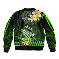 Green and black bomber jacket with Polynesian shark and tiki patterns, hibiscus, ribbed hem