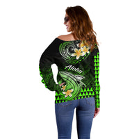 Off-shoulder sweater back with green Polynesian shark, floral design, and Aloha text