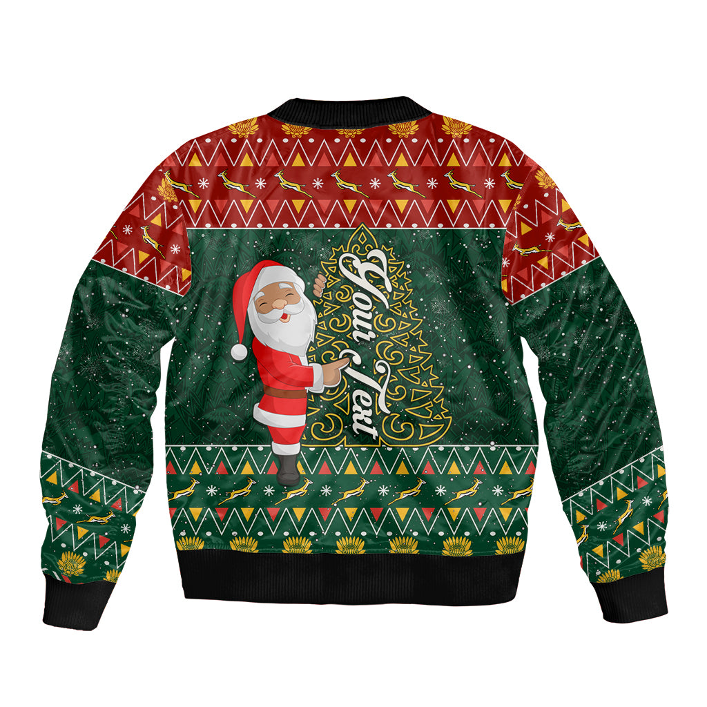 Unisex bomber jacket in red and green with Santa holding tree illustration, ribbed cuffs.