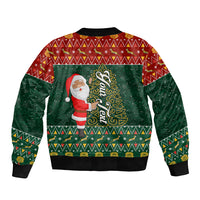 Unisex bomber jacket in red and green with Santa holding tree illustration, ribbed cuffs.