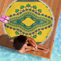 Round yellow beach blanket with green and blue dashiki medallion design and white fringe edge