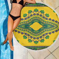 Round yellow beach blanket with green and blue floral dashiki motif and white fringe border