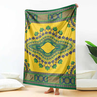 Yellow dashiki blanket with central green medallion and blue-green decorative stripes.