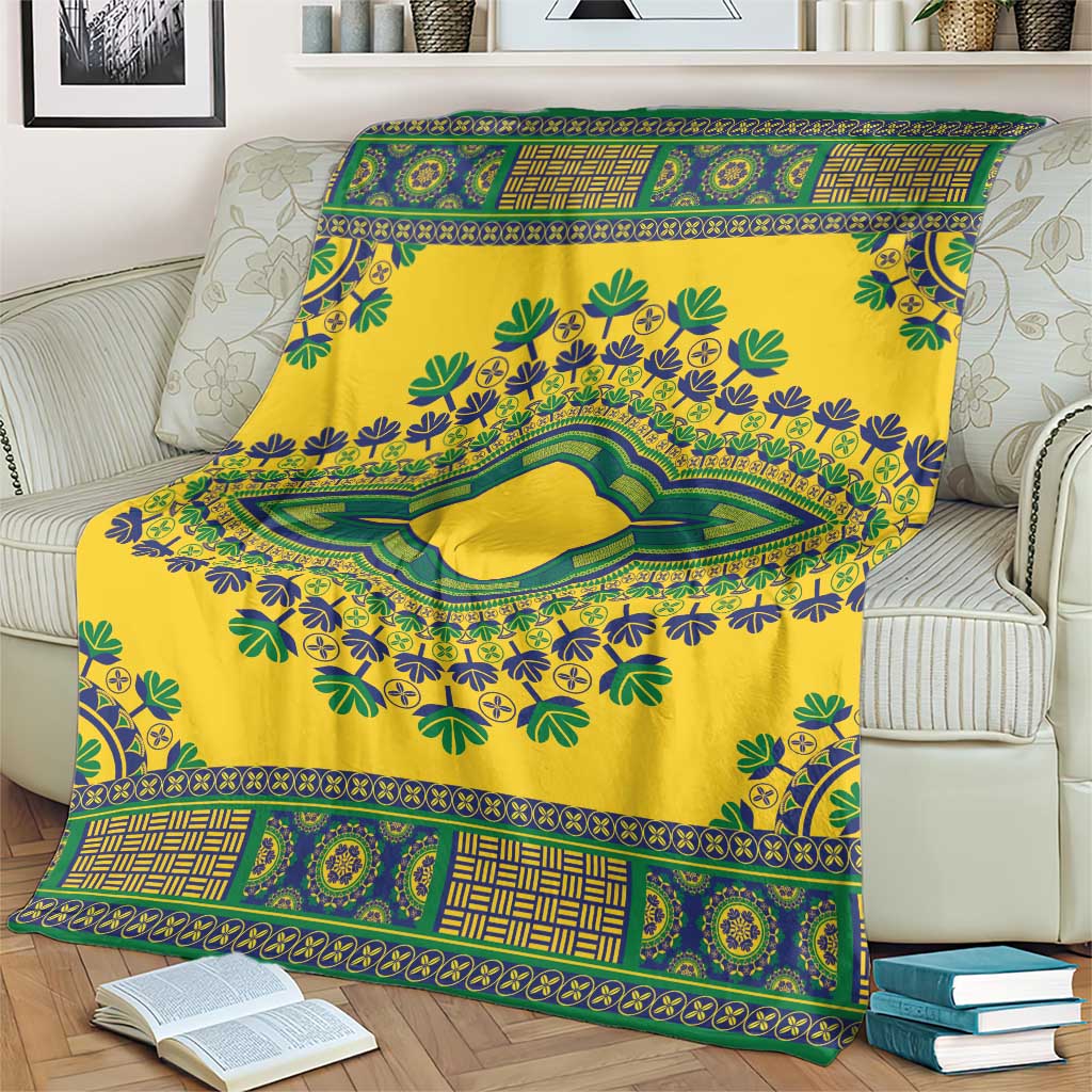 Yellow dashiki blanket with patterned border and central green oval medallion on couch.
