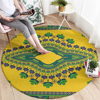Yellow round dashiki patterned carpet with green and blue floral and border motifs