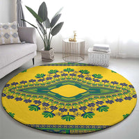 Yellow round carpet with central green diamond and blue leaf motifs