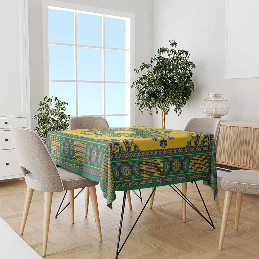 Yellow dashiki tablecloth with teal-green geometric pattern on dining table