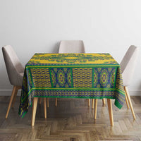 Yellow dashiki tablecloth with teal-green patterned bands on square dining table