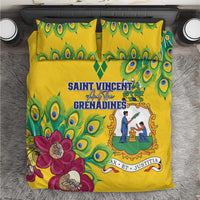 Yellow bedding set close-up with peacock eye pattern, purple flower print, and emblem