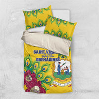 Yellow bedding set with peacock feathers and purple flowers, flat top view with pillows