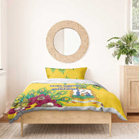 Yellow comforter with peacock feather pattern and crest-like emblem, matching pillow