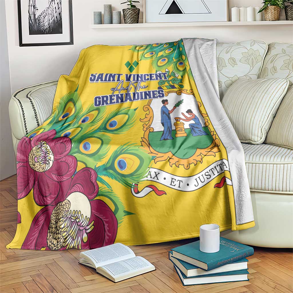 Yellow blanket with stylized peacock feather design and magenta floral accents, draped on a chair