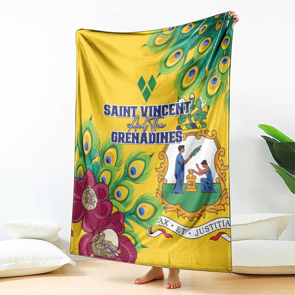 Yellow throw blanket with peacock feather artwork, decorative crest, and magenta flower motifs