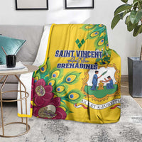 Yellow blanket draped over a sofa, peacock feather pattern with magenta flowers and blue crest