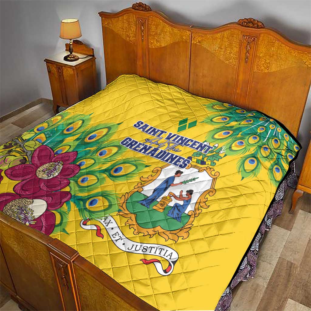 Yellow quilt with peacock feather pattern and floral crest, decorative border