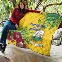 Yellow quilt with peacock feather and floral graphic, central emblem and text