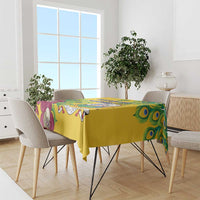 Yellow tablecloth on dining table with peacock feather motif and illustrated border